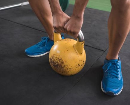 Close-up of a man's feet and kettlebell