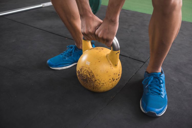 Close-up of a man's feet and kettlebell