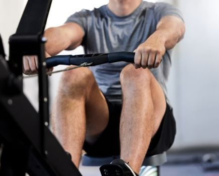 Close-up of a man using a rowing machine