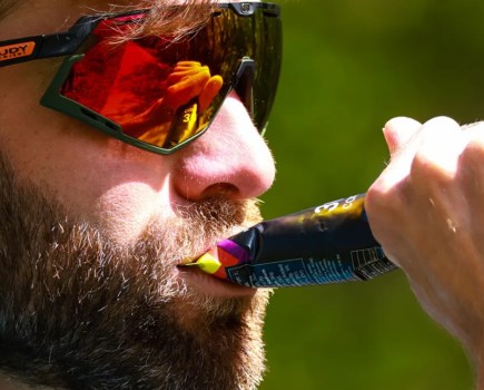 Close-up of a male runner taking an energy gel