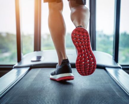 Close-up of a man's feet on a treadmill