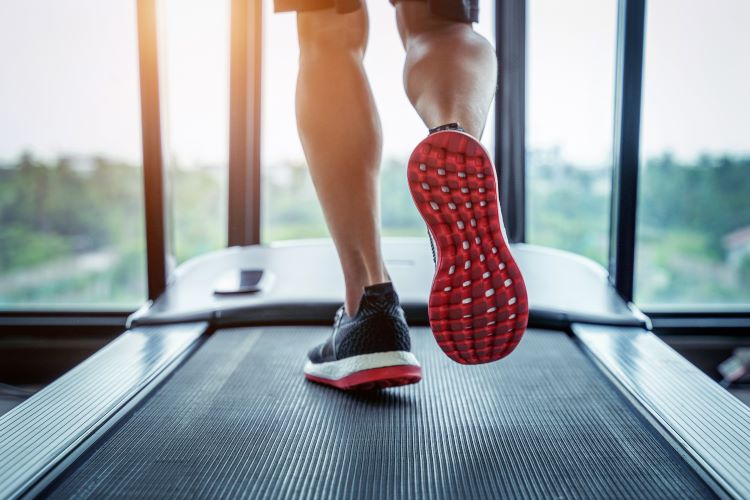 Close-up of a man's feet on a treadmill