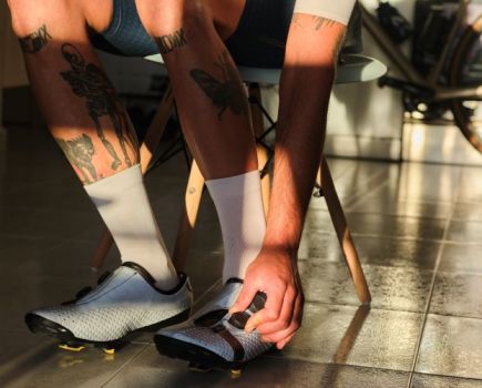 Close-up of a man putting on cycling shoes