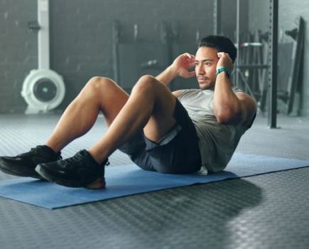 Man doing sit-ups on an exercise mat