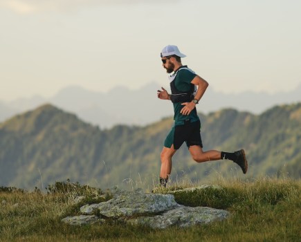 Young sportsman during a long distance trail run in the mountains