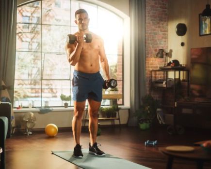 Man using gym equipment at home