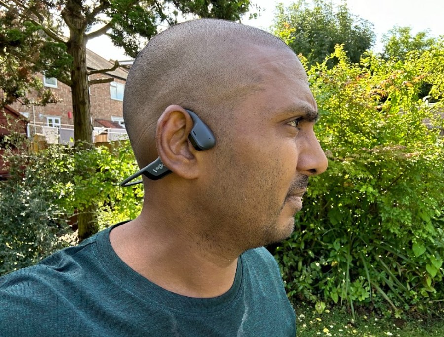 Close-up of a runner wearing open-ear headphones